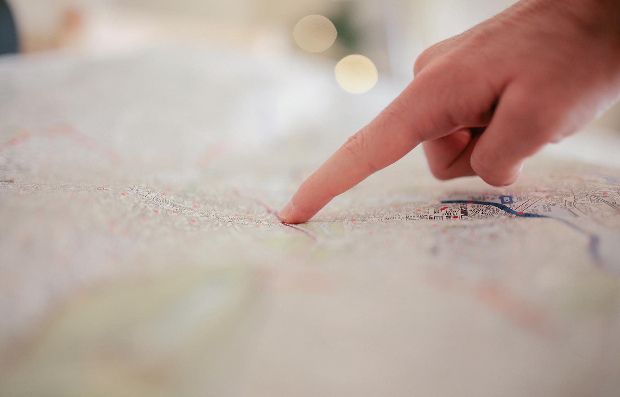 Finger pointing to a map